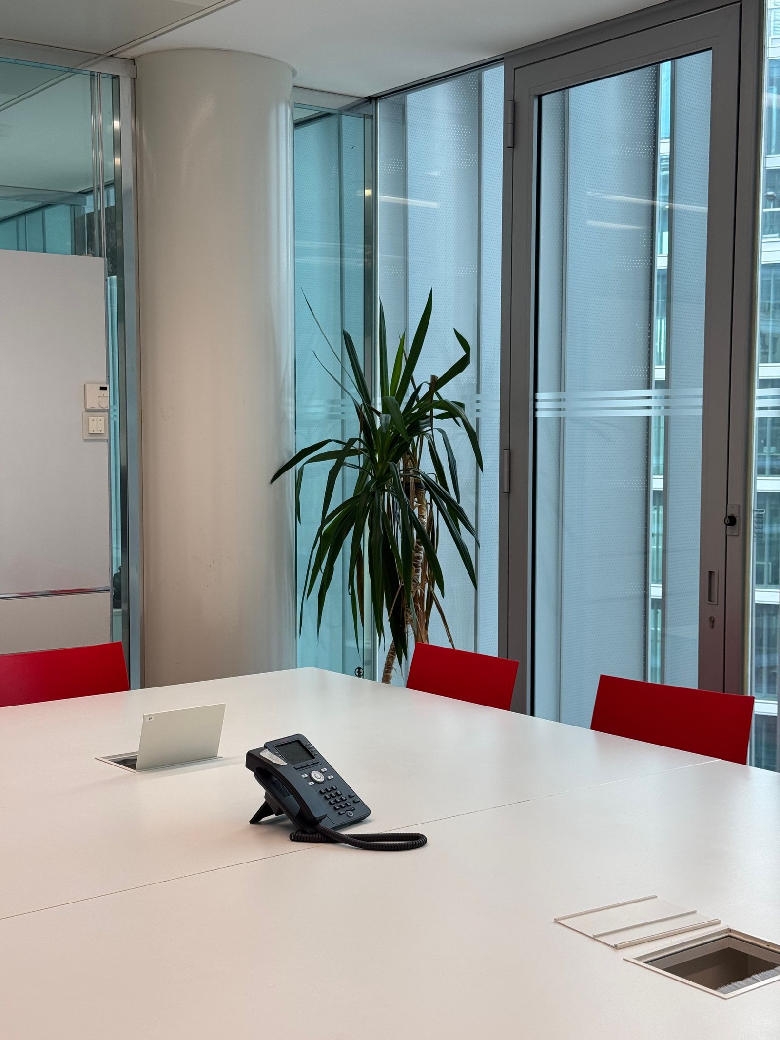Yealink-style desk phone on a conference table for a growing team